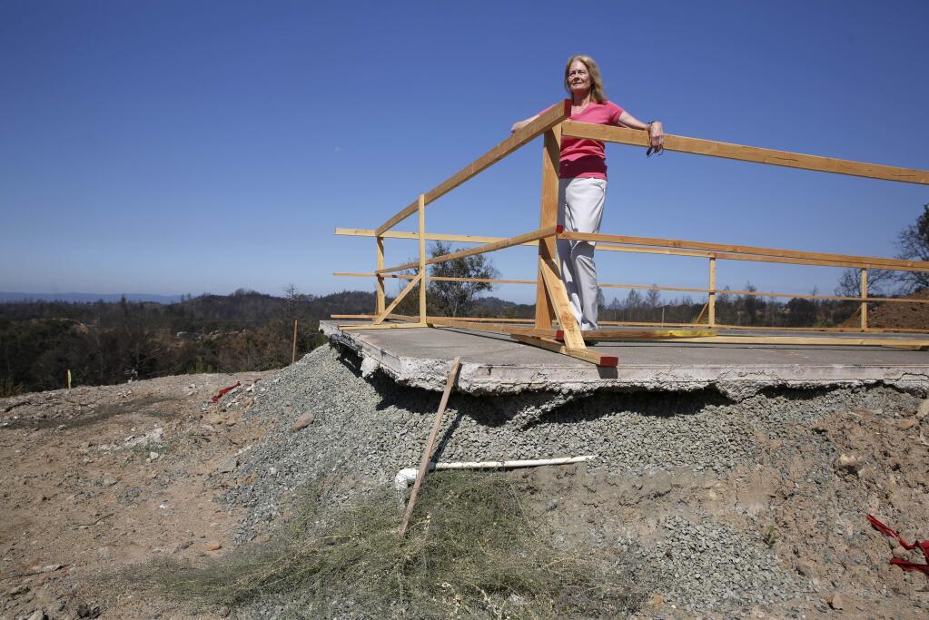 Diana Breslich stands on the patio surrounding her pool that was level with the ground before the Tubbs fire. Breslich says FEMA contractors removed too much soil during the excavation cleanup, forcing her to spend over 50,000 bringing in truckloads of soil to fill in the property. Photo taken at the site of her former home on Crystal Springs Court in Santa Rosa on Thursday, Aug. 2, 2018. (BETH SCHLANKER/ PD)
