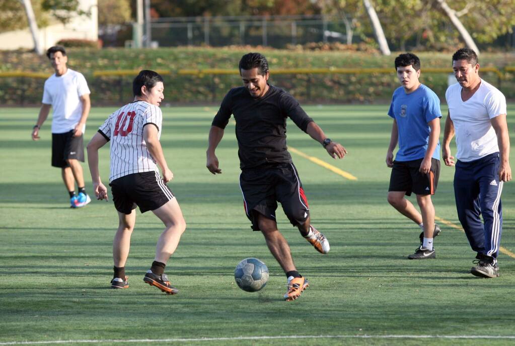 A friendly soccer game being played on the turf field at Lucchesi Park in Petaluma on Monday, November 17, 2014. (SCOTT MANCHESTER/ARGUS-COURIER STAFF)