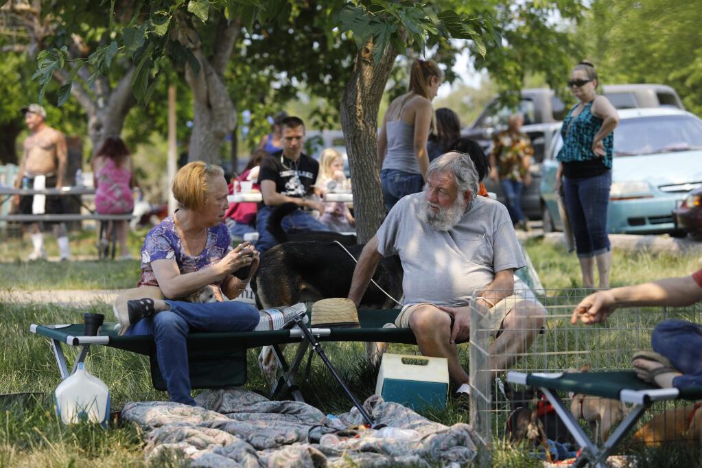 People wait at the Clearlake Oaks Moose Lodge after being evacuated due to the Pawnee fire on Sunday, June 24, 2018 in Clearlake Oaks, California. (BETH SCHLANKER/ PD)