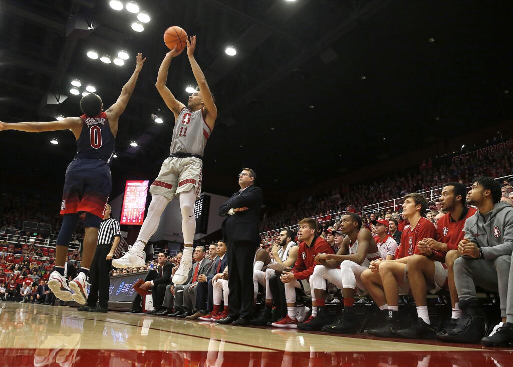 Stanford guard Dorian Pickens (11) takes a 3-point shot over Arizona guard Parker Jackson-Cartwright (0) during the second half of an NCAA college basketball game Saturday, Jan. 20, 2018, in Stanford, Calif. Arizona won 73-71. (AP Photo/Tony Avelar)