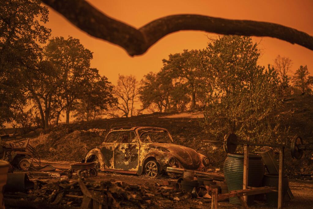 A Volkswagen Beetle scorched by a wildfire called the Carr Fire rests at a residence in Redding, Calif., Friday, July 27, 2018. (AP Photo/Noah Berger, File)
