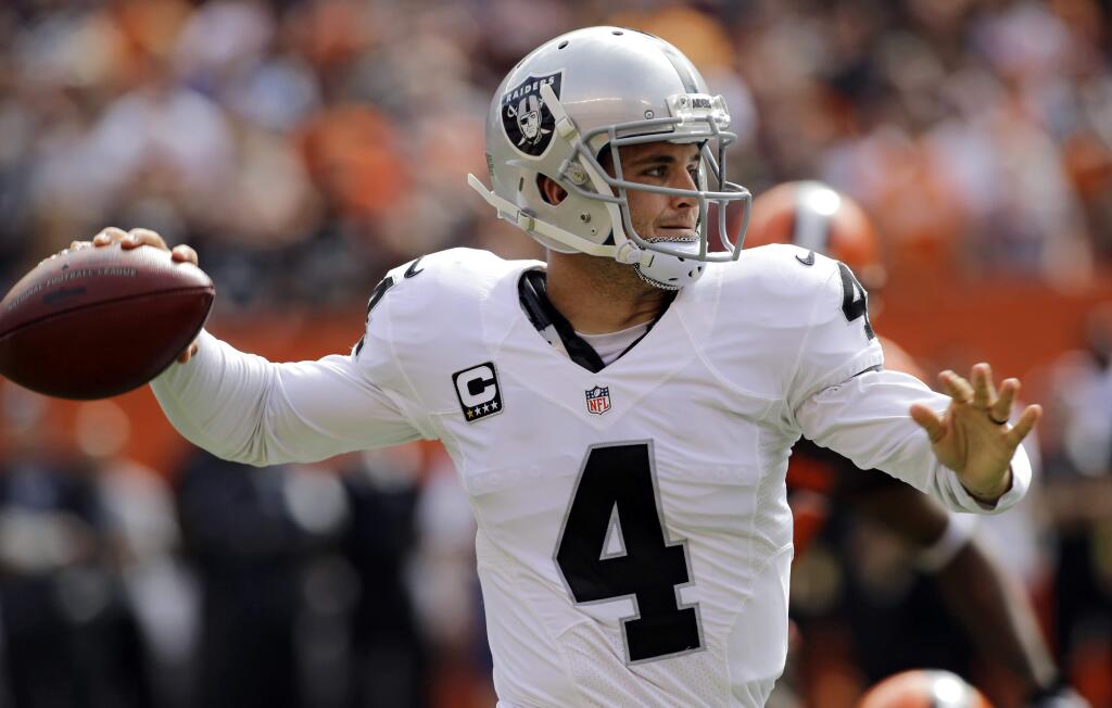 Oakland Raiders quarterback Derek Carr throws in the first half of an NFL football game against the Cleveland Browns, Sunday, Sept. 27, 2015, in Cleveland. (AP Photo/Aaron Josefczyk)