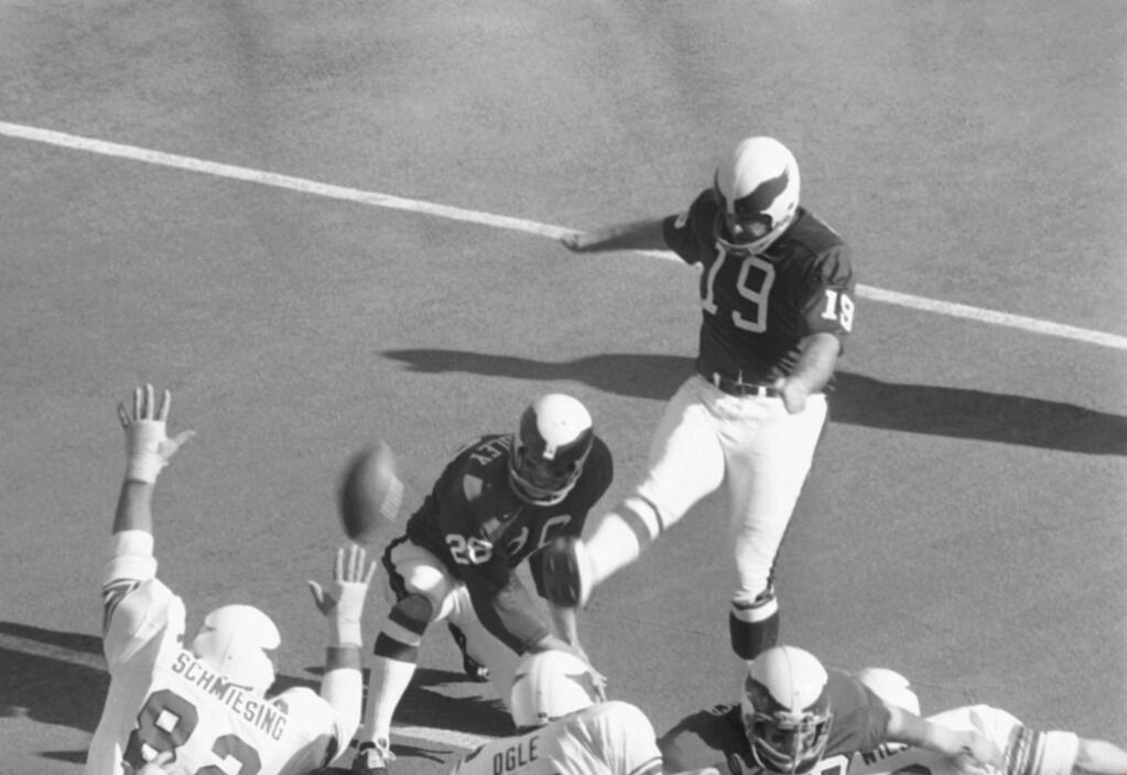 FILE - In this Nov. 22, 1971 file photo, Philadelphia Eagles Tom Dempsey (19) kicks a point after a touch down during the first period on his way to 13 points, during an NFL football game against the St. Louis Cardinals in St. Louis, Mo. Dempsey, who played in the NFL despite being born without toes on his kicking foot and made a record 63-yard field goal, died late Saturday, April 4, 2020, in New Orleans while struggling with complications from the new coronavirus, his daughter said. He was 73 years old. (AP Photo/File)