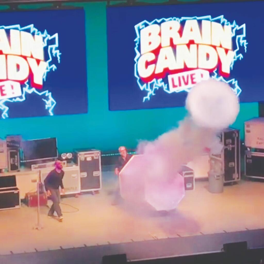 Michael Stevens and Adam Savage onstage creating a giant smoke ring. (YouTube)