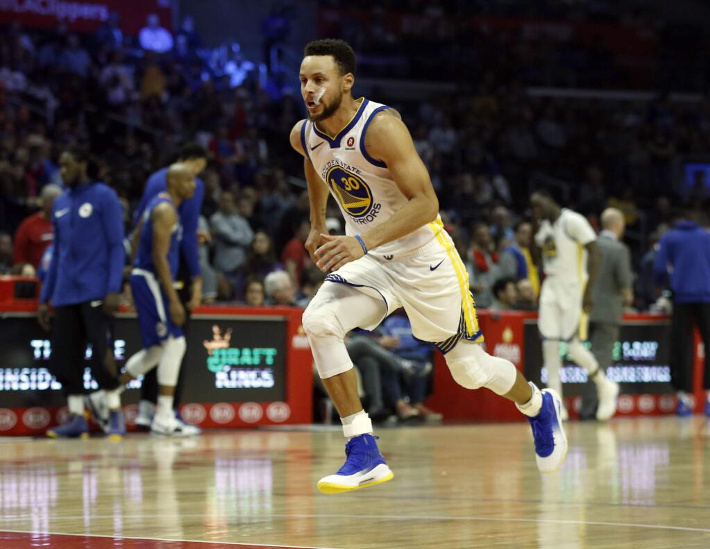 Golden State Warriors guard Stephen Curry warms up with a sprint before of an NBA basketball game against the Los Angeles Clippers in Los Angeles, Saturday, Jan. 6, 2018. (AP Photo/Alex Gallardo)
