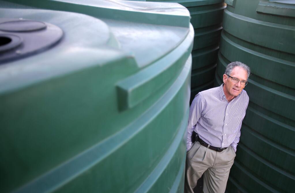 Rich Hutchison, purchasing agent for Friedman's Home Improvement, in recent years has noted an increase in sales of water storage tanks. These particular tanks can be used for both water storage and rainwater collection. (Christopher Chung / The Press Democrat, 2014)