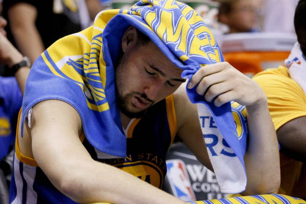 Golden State Warriors guard Klay Thompson (11) reacts in the final moments against the Oklahoma City Thunder in Game 4 of the NBA basketball Western Conference finals in Oklahoma City, Tuesday, May 24, 2016. The Thunder won 118-94. (AP Photo/Sue Ogrocki)