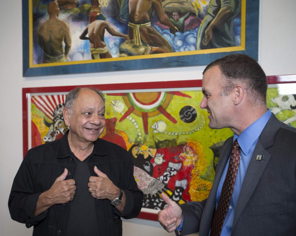Comedian and actor Cheech Marin, left, talks with Riverside Mayor Rusty Bailey in front of Cheech Marin's Chicano art collection on display at the Riverside Art Museum Tuesday, April 25, 2017 in Riverside, Calif. (Allen J. Schaben/Los Angeles Times/TNS)