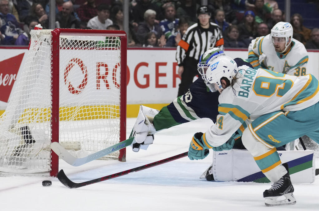 The Sharks’ Alexander Barabanov misses the net on a shot attempt against Canucks goalie Spencer Martin during the second period Tuesday, Dec. 27, 2022, in Vancouver, British Columbia. (Darryl Dyck / Canadian Press)