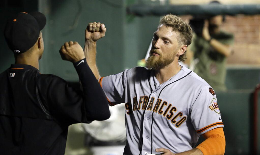 San Francisco Giants' Hunter Pence celebrates with a teammate in the dugout after hitting a solo home run in the 11th inning of a game against the Texas Rangers in Arlington, Texas, Saturday, Aug. 1, 2015. The Giants won 9-7. (AP Photo/LM Otero)