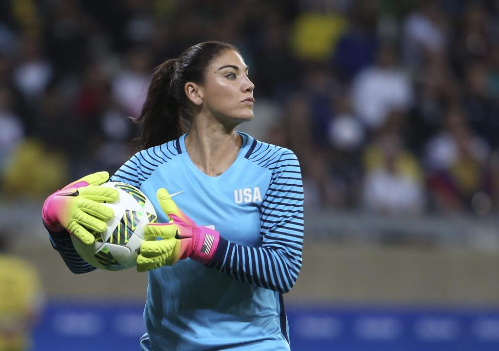 In this Aug. 3, 2016, file photo, U.S. goalkeeper Hope Solo takes the ball during a women's Olympic match against New Zealand in Belo Horizonte, Brazil. Solo has been suspended form the team for six months for what U.S. Soccer termed conduct 'counter to the organization's principles.' The suspension is effective immediately. U.S. Soccer President Sunil Gulati said Wednesday, Aug. 24, that comments Solo made after the U.S. lost to Sweden during the Rio Olympics were 'unacceptable and do not meet the standard of conduct we require from our National Team players.' (AP Photo/Eugenio Savio, File)