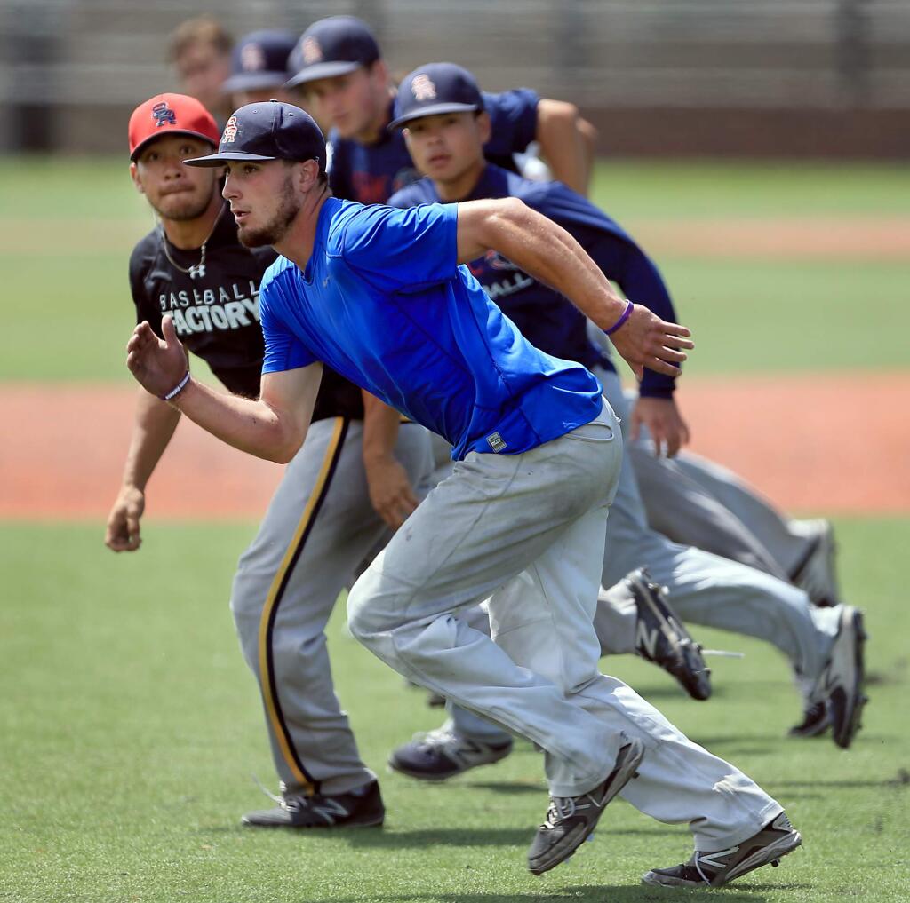 SRJC's Daniel Teasley and his Bear Cubs teammates practice base running drills at Cook Sypher Field on the Santa Rosa Junior College campus, Wednesday May 24, 2017 in Santa Rosa. (Kent Porter / Press Democrat) 2017