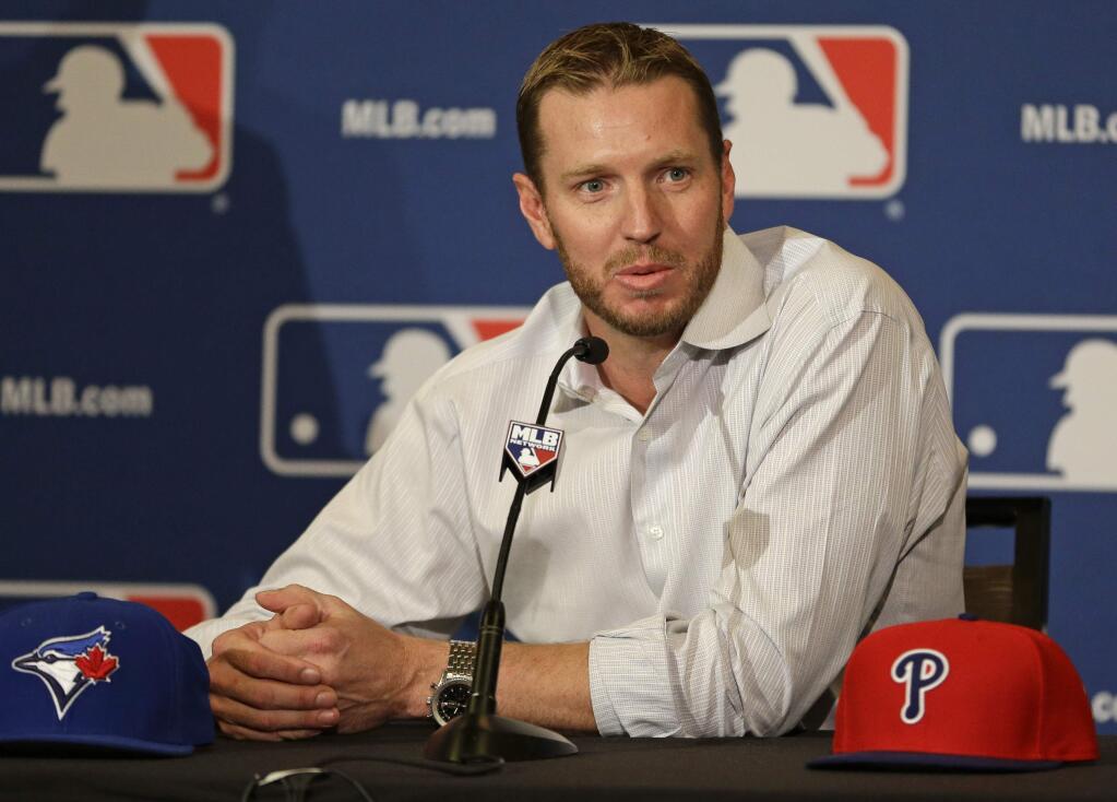 In this Dec. 9, 2013, file photo, two-time Cy Young Award winner Roy Halladay answers questions after announcing his retirement after 16 seasons in the major leagues with Toronto and Philadelphia. (AP Photo/John Raoux, File)