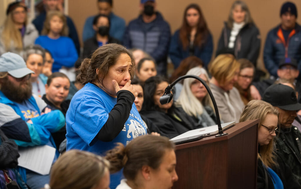 Nicole Guerra, a student supervisor with the Bellevue Union School District, wipes away tears Tuesday, Feb. 20, 2024, as she urges school board members to reconsider a proposal to eliminate 30 staff positions in the small Santa Rosa school district. (John Burgess / The Press Democrat)