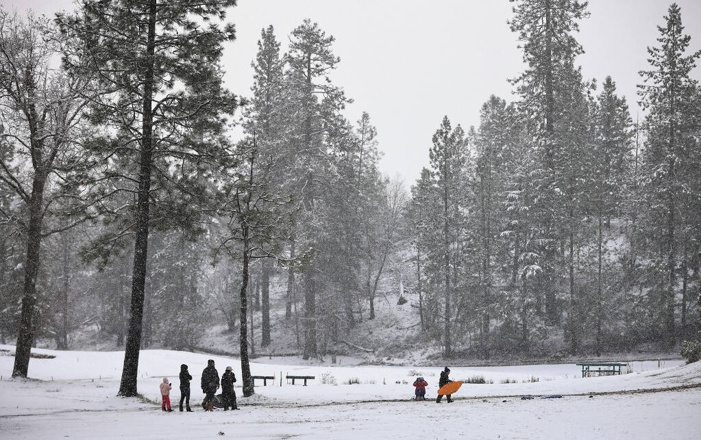 Snow continues to fall on Cobb Mountain as residents react in kind with some sledding, Tuesday, Dec. 28, 2021. (Kent Porter / The Press Democrat) 2021
