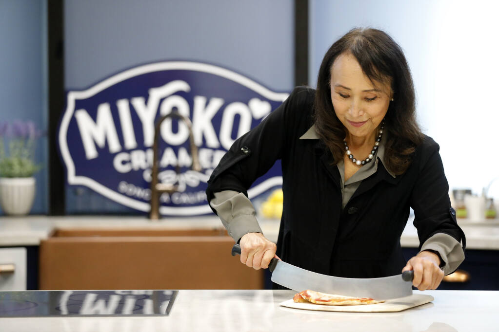 Miyoko Schinner, the founder and CEO of Miyoko's Creamery cuts pizza made with liquid Vegan Pizza Mozzarella cheese in Petaluma on Thursday, Oct. 28, 2021. (Beth Schlanker/The Press Democrat)