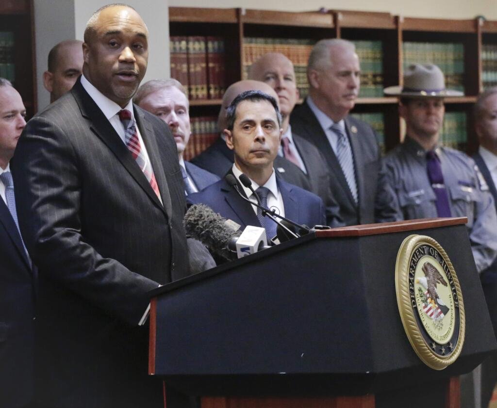 U.S. attorney Robert Capers, left, speaks during a news conference, announcing charges for Mexican drug kingpin Joaquin 'El Chapo' Guzman as the murderous architect of a three-decade-long web of violence, corruption and drug trafficking, Friday Jan. 20, 2017, in the Brooklyn borough of New York. Extradited Thursday from Mexico, Guzman was due later Friday in a federal court in Brooklyn. Prosecutors have sought to bring him to a U.S. court for years while he made brazen prison escapes and spent years on the run in Mexico. (AP Photo/Mark Lennihan)