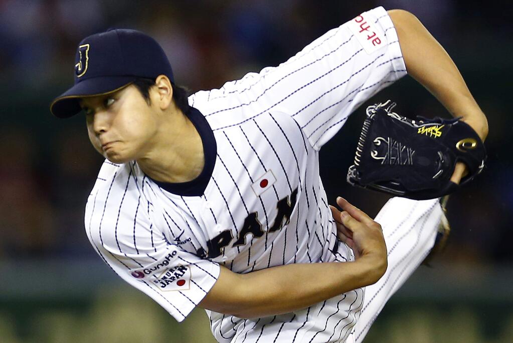In this Nov. 19, 2015, file photo, Japan's starter Shohei Otani pitches against South Korea during the first inning of their semifinal game at the Premier12 world baseball tournament at Tokyo Dome in Tokyo. (AP Photo/Shizuo Kambayashi, File)