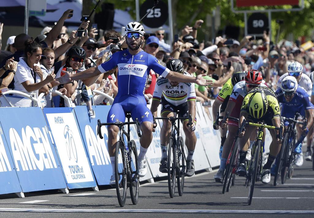 Fernando Gaviria celebrates as he crosses the finish line to win the fifth stage of the Amgen Tour of California, Thursday, May 17, 2018, in Elk Grove, Calif. (AP Photo/Rich Pedroncelli)