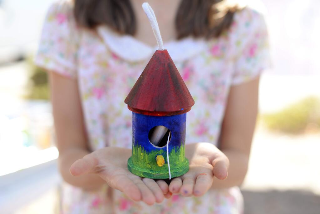Sofia Goldberg, 11, of Glen Ellen, with her finished painted birdhouse which contains a rolled note describing her personal experience of the 2017 October Fires at Jack London Village in Glen Ellen Saturday, September 8, 2018.(Photo: Erik Castro/for The Press Democrat)