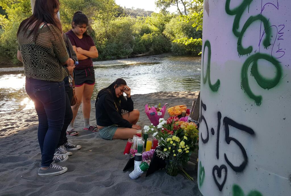 Friends of a 16-year-old Cloverdale girl who died after she was struck by a car in suspected street race mourn the loss on Saturday, June 6, 2015, east of Cloverdale. (Derek Moore / The Press Democrat)