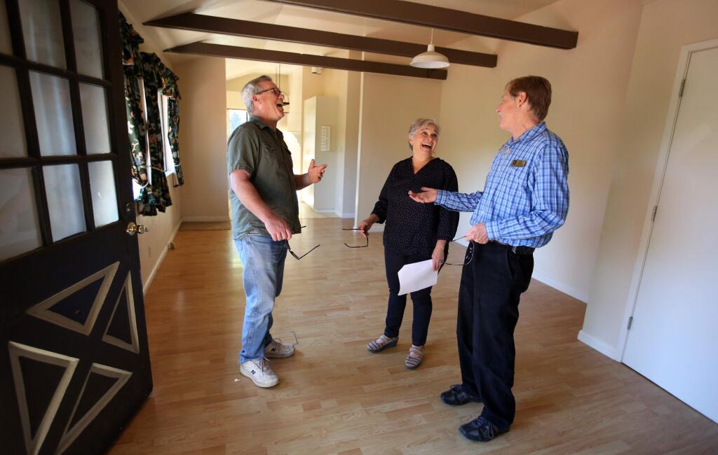 Coldwell Banker's John Duran, right, talks with his clients Debra Franzman, center, John Franzman, during a tour of a home for sale on Potter Creek Road in Santa Rosa , Saturday, April 11, 2015. (CRISTA JEREMIASON / The Press Democrat)