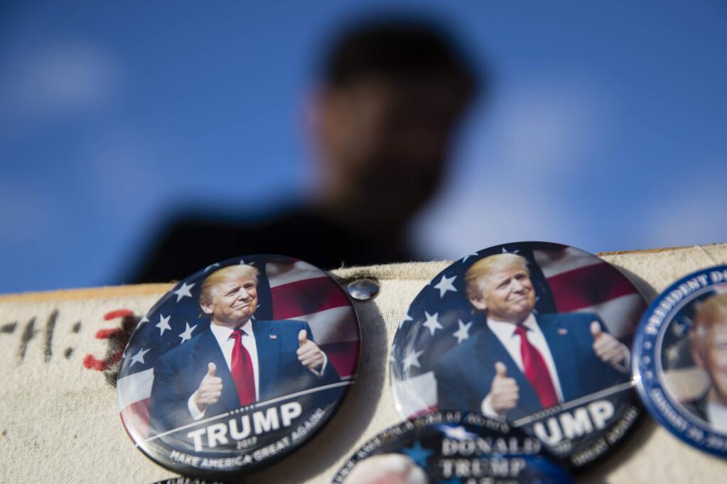 Buttons for sale are posted as preparations continue for Friday's inauguration of Donald Trump in Washington, Wednesday, Jan. 18, 2017.(AP Photo/Matt Rourke)