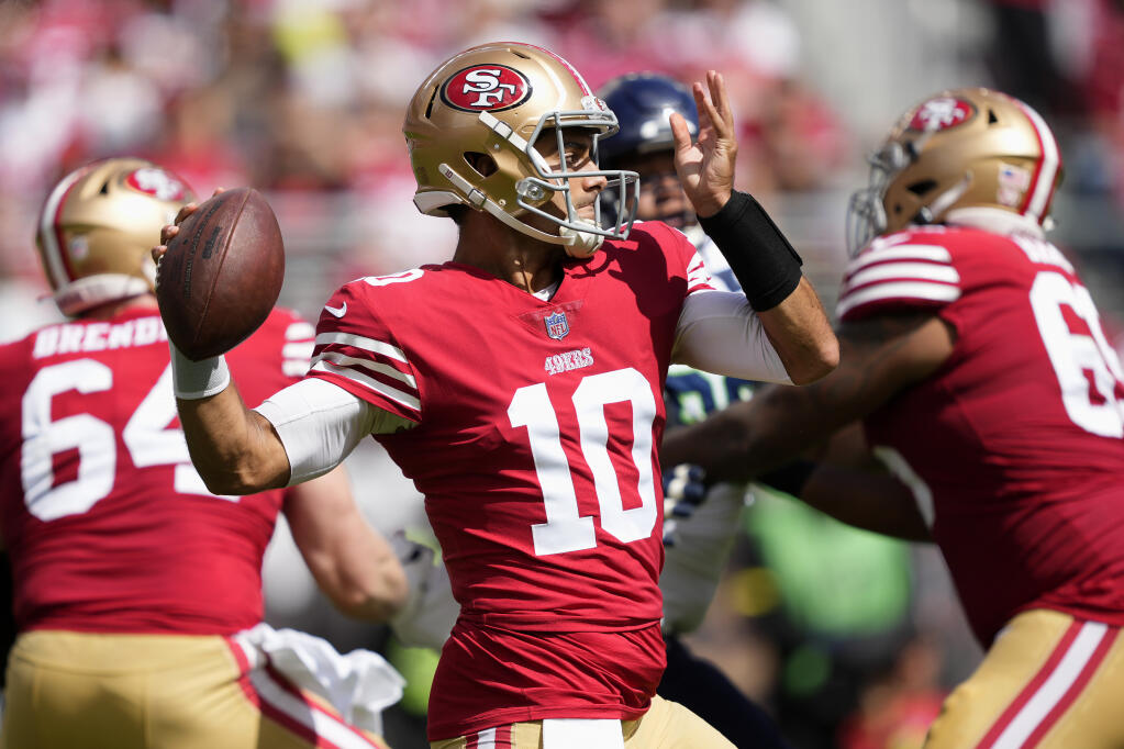 San Francisco 49ers quarterback Jimmy Garoppolo (10) passes against the Seattle Seahawks during the first half of an NFL football game in Santa Clara, Calif., Sunday, Sept. 18, 2022. (AP Photo/Tony Avelar)