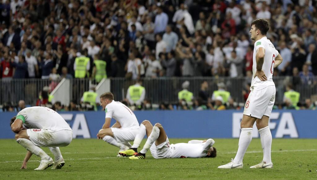 England's players reacts on the pitch disappointed after losing the semifinal match between Croatia and England at the 2018 soccer World Cup in the Luzhniki Stadium in Moscow, Russia, Wednesday, July 11, 2018. (AP Photo/Matthias Schrader)