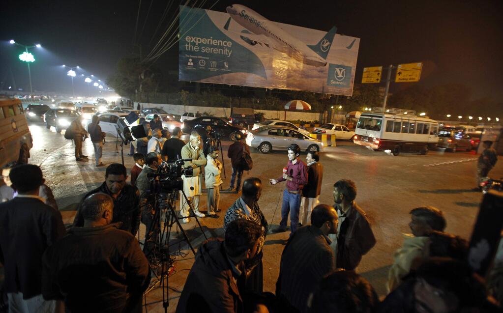 Pakistani media and residents gather at Benazir Bhutto International Airport following a report that a passenger plane from Chitral, in the country's north, had crashed near a village near the town of Havelian, in Islamabad, Pakistan, Wednesday, Dec. 7, 2016. Pakistan International Airlines said that the ATR-42 aircraft carrying around 40 passengers and crew lost touch with the control tower and that all resources are being mobilized. (AP Photo/Anjum Naveed)