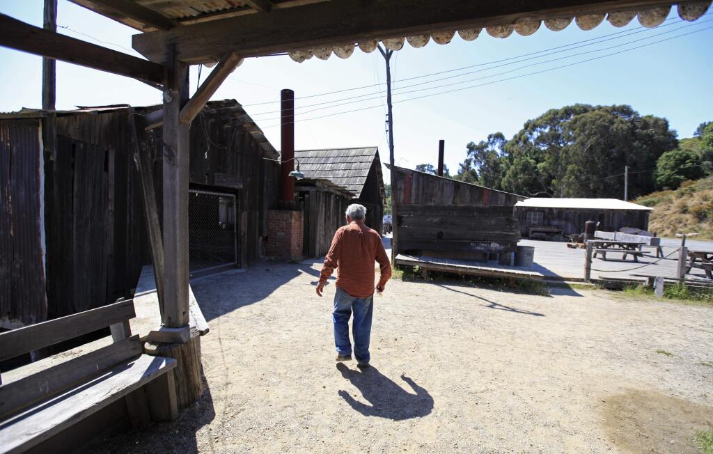 FILE - In this file photo taken Friday, July 15, 2011, park resident Frank Quan walks to open the gate to the pier at China Camp State Park, Calif. Quan, the last of the China Camp shrimpers, the remaining resident of a shrimping village established by Chinese immigrants on the northern shore of San Francisco Bay, died on Aug. 15, 2016. He was 90. (AP Photo/Eric Risberg, File)