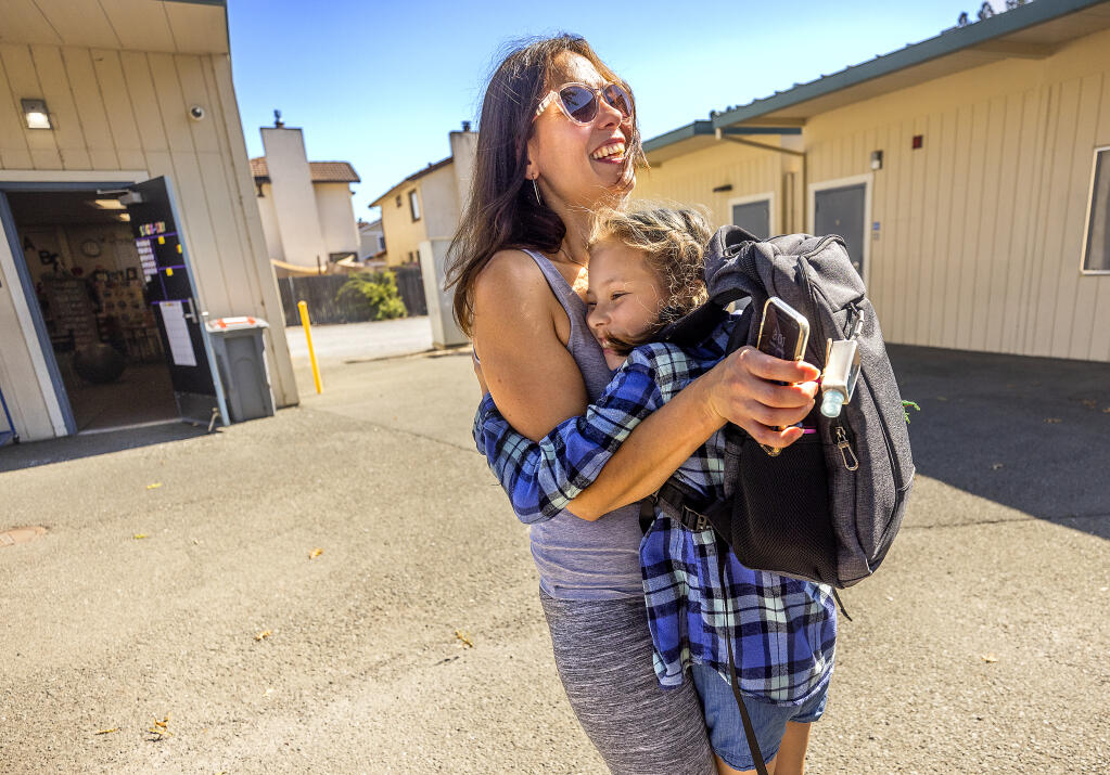 Iryna Kulyk, a native of Chernihiv, Ukraine, hugs her daughter Myroslava Stetsenko, 8, at the end of day at Marguerite Hahn Elementary School in Rohnert Park Sept. 7, 2022. Kulyk, her two children and her mother-in-law fled Ukraine to Poland and ended up in Sonoma County when a group of locals sponsored the family. (John Burgess/The Press Democrat)