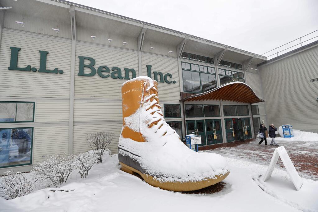 Customers leave the L.L. Bean retail store in Freeport, Maine. An unhappy customer is suing L.L. Bean over its new return policy, claiming the company broke a vow to customers. The lawsuit in federal court in Chicago contends customers bought items because of L.L. Bean's unlimited 'satisfaction' guarantee. The lawsuit accuses L.L. Bean of breach of warranty. (ROBERT F. BUKATY / Associated Press)