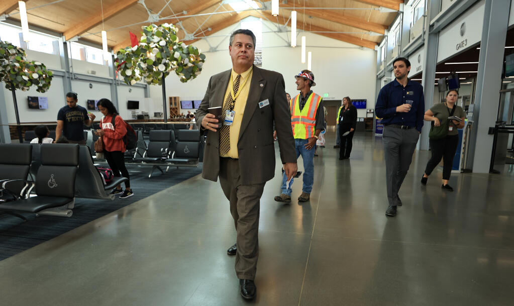 Jon Stout, manager of the Charles M. Schulz-Sonoma County Airport in Santa Rosa, leads a tour of the completed passenger terminal, Wednesday, Aug. 23, 2023. A ceremony was held at the facility to celebrate the final steps of the airport expansion. (Kent Porter / The Press Democrat file)