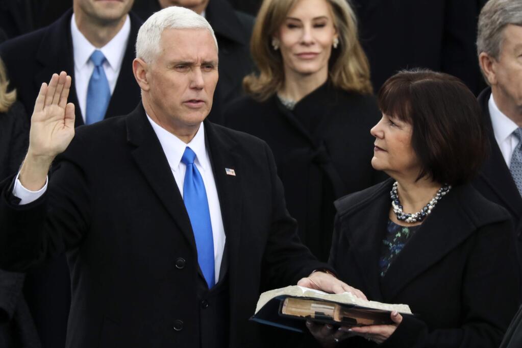 Vice President Mike Pence is sworn in as this wife Karen holds the bible during the 58th Presidential Inauguration at the U.S. Capitol in Washington, Friday, Jan. 20, 2017. (AP Photo/Andrew Harnik)