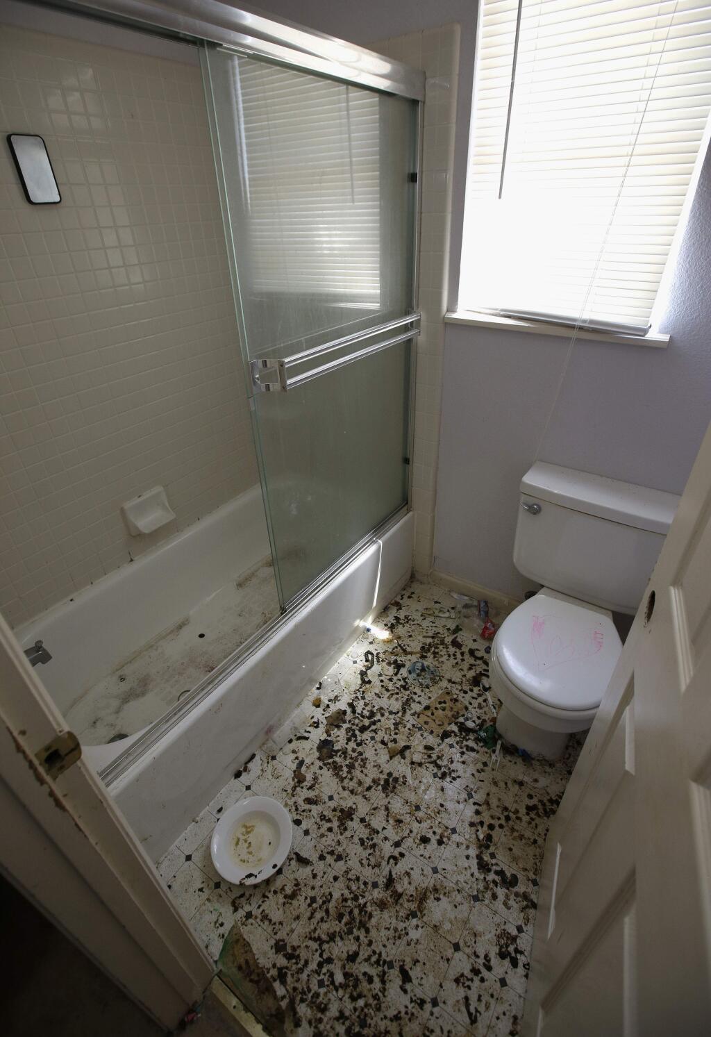 The bathroom is strewn with feces at a home in Fairfield, Calif., Monday, May 14, 2018, where authorities removed 10 children and charged their father with torture and their mother with neglect after an investigation revealed a lengthy period of severe physical and emotional abuse. (AP Photo/Rich Pedroncelli)