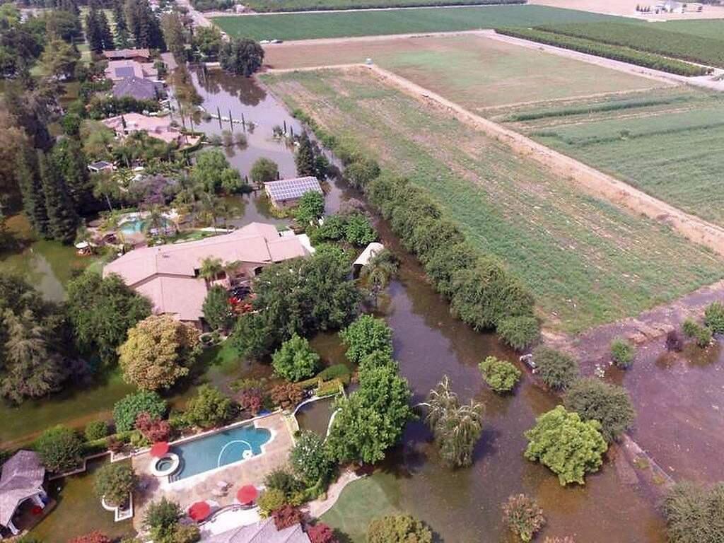 This June 25, 2017, photo taken by an unmanned aerial vehicle and released by the Tulare County Sheriff's Office shows flooding from the Kings River at the Kings River Golf and Country Club in Kingsburg, Calif. Authorities say 90 homes remain under mandatory evacuation orders following levee breaches along the Kings River in Central California. The Kings River began to flood Wednesday about 25 miles (40 kilometers) north of Fresno as temperatures soared, melting snow in the Sierra Nevada and sending it downstream. (Tulare County Sheriff's Office via AP)