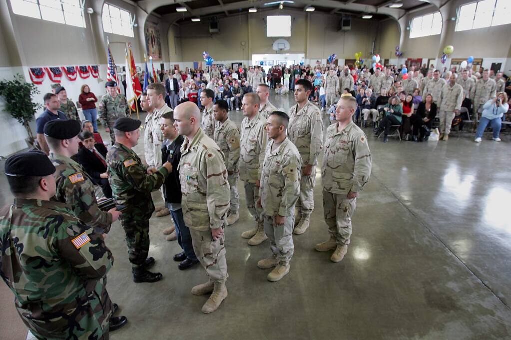 Members of the National Guard 579th Engineer Battalion receive the U.S. Army commendation medal for their service in Iraq at the Petaluma armory in 2005. (PD File)