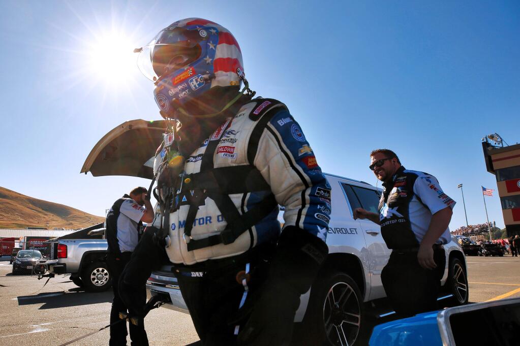 Funny car driver John Force prepares to enter his car during the nitro qualifying session for the NHRA Sonoma Nationals at Sonoma Raceway in Sonoma on Friday, July 26, 2019. (Alvin Jornada / The Press Democrat)
