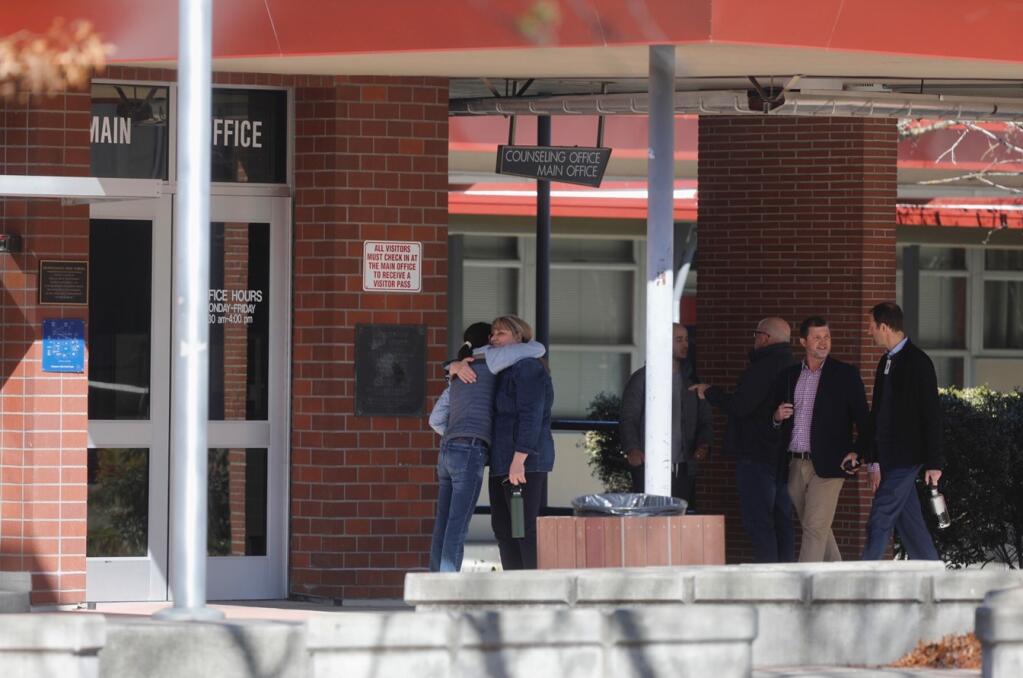 People gather outside the main office after students were released for the day after a fatal fight at Montgomery High School in Santa Rosa, Wednesday, March 1, 2023. (Beth Schlanker / The Press Democrat)