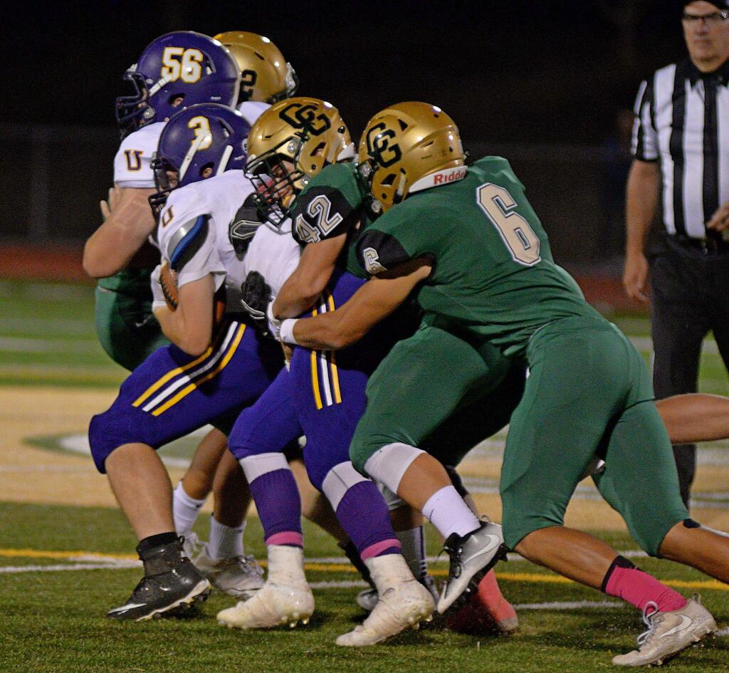 SUMNER FOWLER/FOR THE ARGUS-COURIERCasa Grande tackers Zian Kovach (42) and Adam Lopez combine to bring down a Ukiah ball carrier in a game won by Ukian, 37-21.