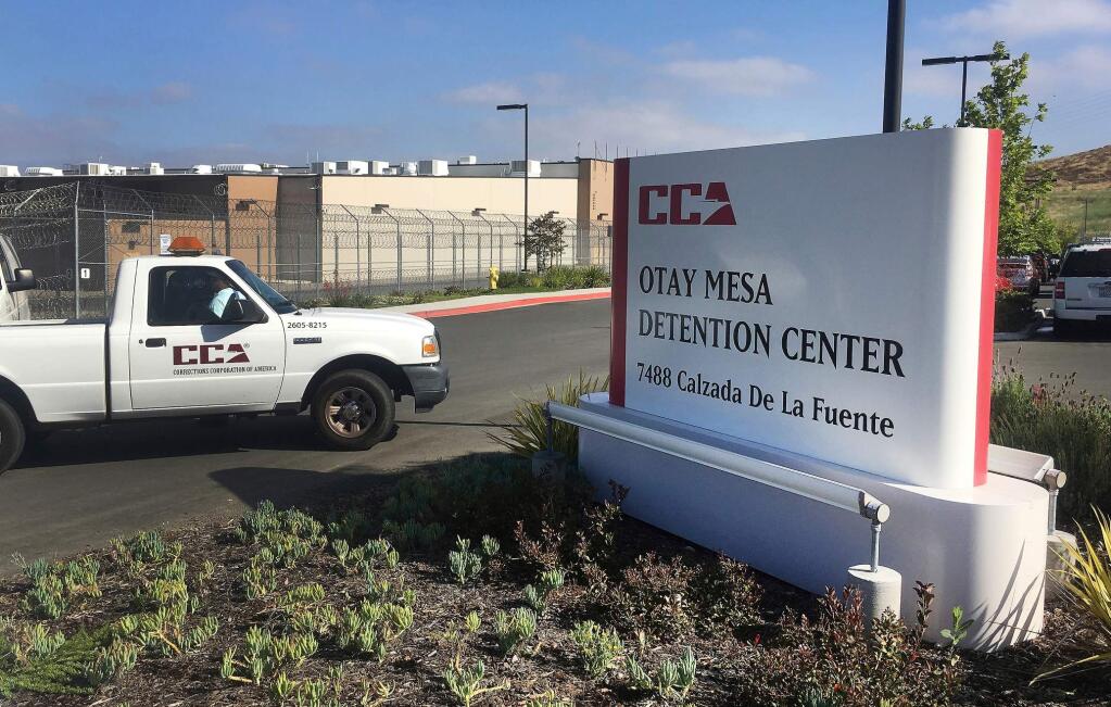 FILE - In this June 9, 2017, file photo, a vehicle drives into the Otay Mesa detention center in San Diego. An immigration detainee has died at a Southern California hospital where he was being treated for a brain hemorrhage. U.S. Immigration and Enforcement says 37-year-old Nebane Abienwi died Tuesday, Oct. 1, 2019, in Chula Vista. Abienwi is from Cameroon. ICE says he applied for admission to the United States without proper entry documents on Sept. 5 at the San Ysidro Port of Entry. He was transferred to the Otay Mesa detention center on Sept. 19. (AP Photo/Elliot Spagat, File)
