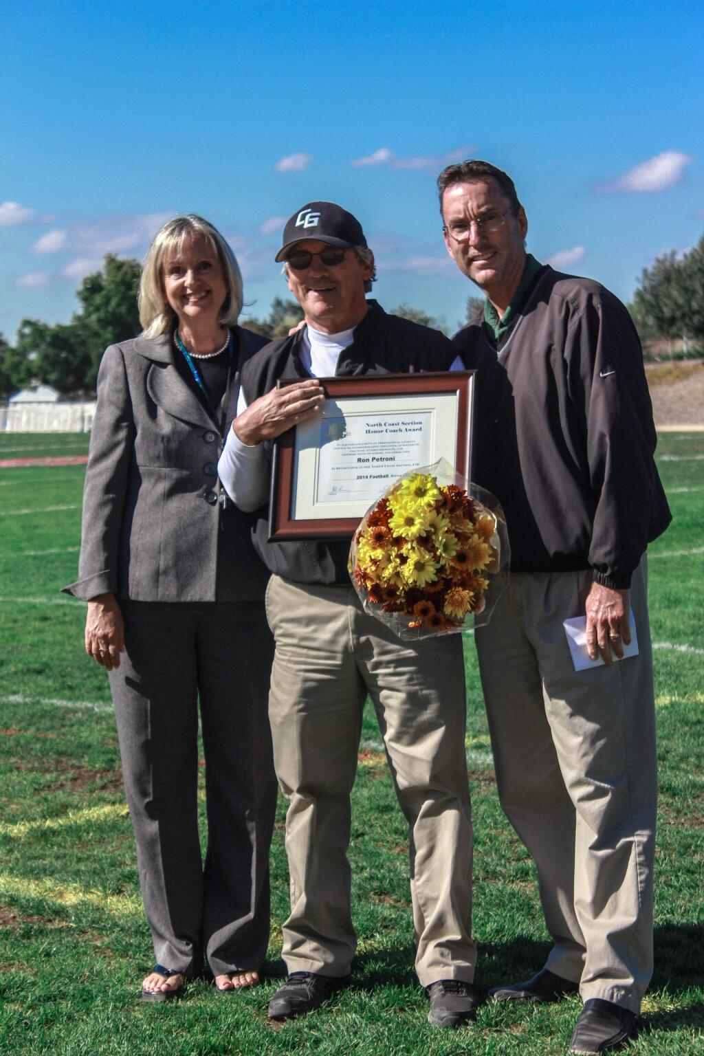 North Coast Section Honor Coach Ron Petroni (center) is flanked by Casa Grande Principal Linda Scheele and athletic director and former football head coach Rick O'Brien as the award is presented to him before the Casa student body.
