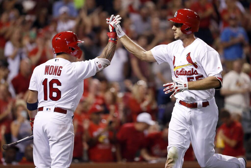 The St. Louis Cardinals' Stephen Piscotty, right, is congratulated by teammate Kolten Wong after hitting a solo home run during the fourth inning against the San Diego Padres Tuesday, Aug. 22, 2017, in St. Louis. (AP Photo/Jeff Roberson)
