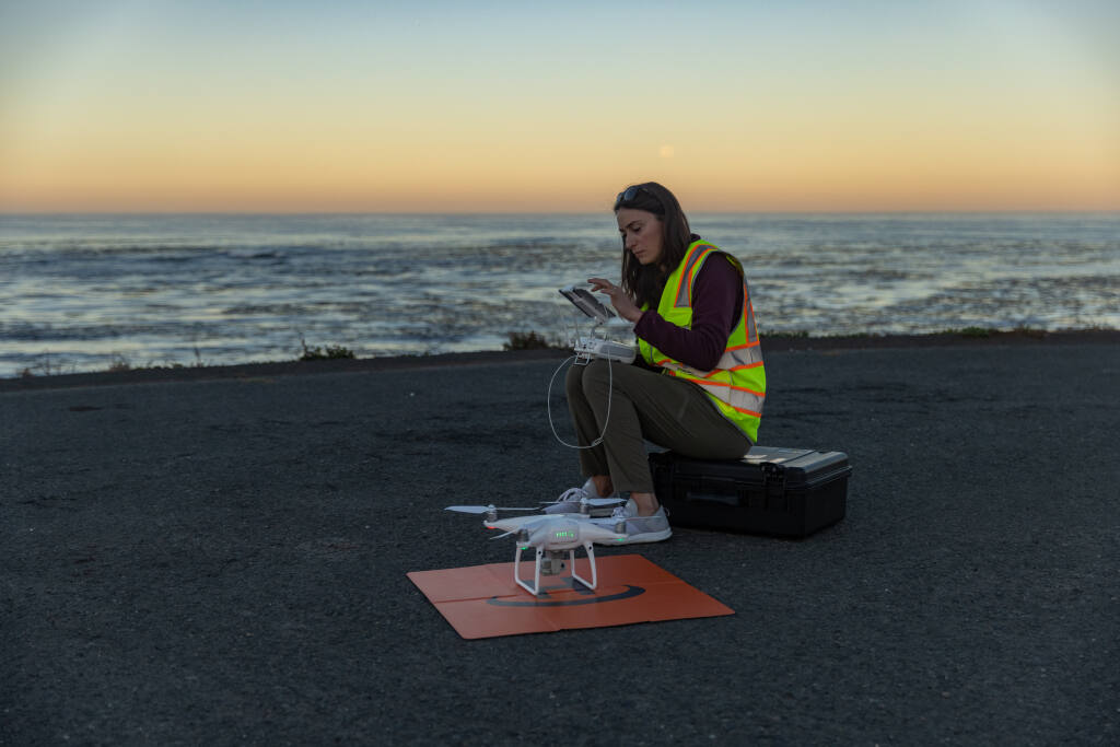 Vienna Saccomanno, an ocean scientist with The Nature Conservancy, uses a drone to map the presence of kelp forests along the Mendocino coast. The drone can measure down to less than an inch, much closer than satellites in space, which have monitored the kelp canopy since the 1980s but can only see kelp patches 100 feet wide. (Ralph Pace, provided by The Nature Conservancy)