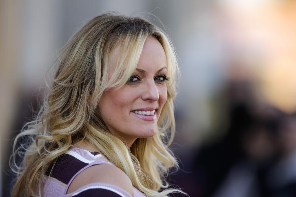 Adult film actress Stormy Daniels attends the opening of the adult entertainment fair 'Venus' in Berlin, Germany, Thursday, Oct. 11, 2018. (AP Photo/Markus Schreiber)