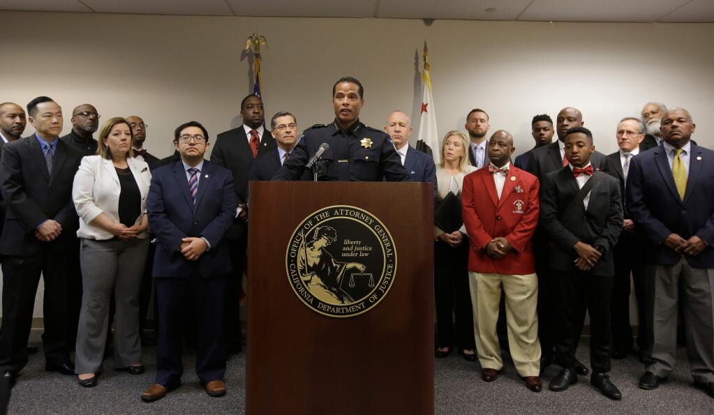 FILE - In this March 27, 2018, file photo, Sacramento Police Chief Daniel Hahn, center, flanked civic and community leaders announced that he has asked Attorney General Xavier Becerra's office to be part of an independent investigation of the shooting death of Stephon Clark by two Sacramento Police officers in Sacramento, Calif. Sacramento police have released over 50 new video and audio clips related to the fatal shooting of the shooting. The Monday, April 16, 2018, video release includes dashboard and body camera footage from responding officers after the March shooting of Stephon Clark. (AP Photo/Rich Pedroncelli, File)