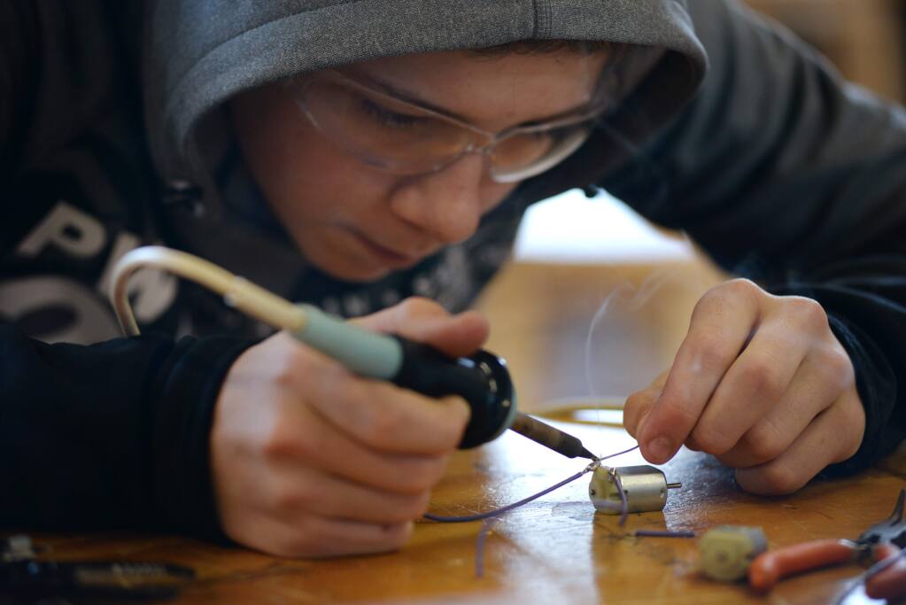 Analy High freshman Iain Douch, 15, soldering some stereo parts during a class at Analy High in Sebastopol where students participate in the hands-on education program known as Project Make. February 5, 2016. (Photo: Erik Castro/for The Press Democrat)