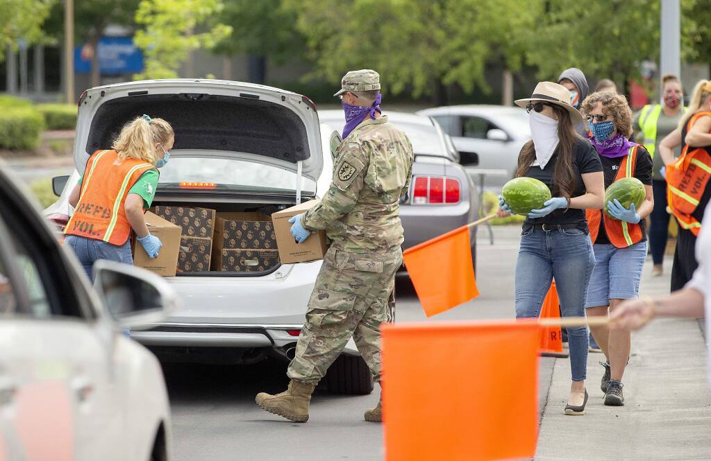 Redwood Empire Food Bank and Sonoma County Vintners Association along with the National Guard volunteer for a drive-thru food distribution to food servers, cooks, kitchen workers, bartenders and others in SoCo's pandemic-distressed hospitality industry.. (photo by John Burgess/The Press Democrat).