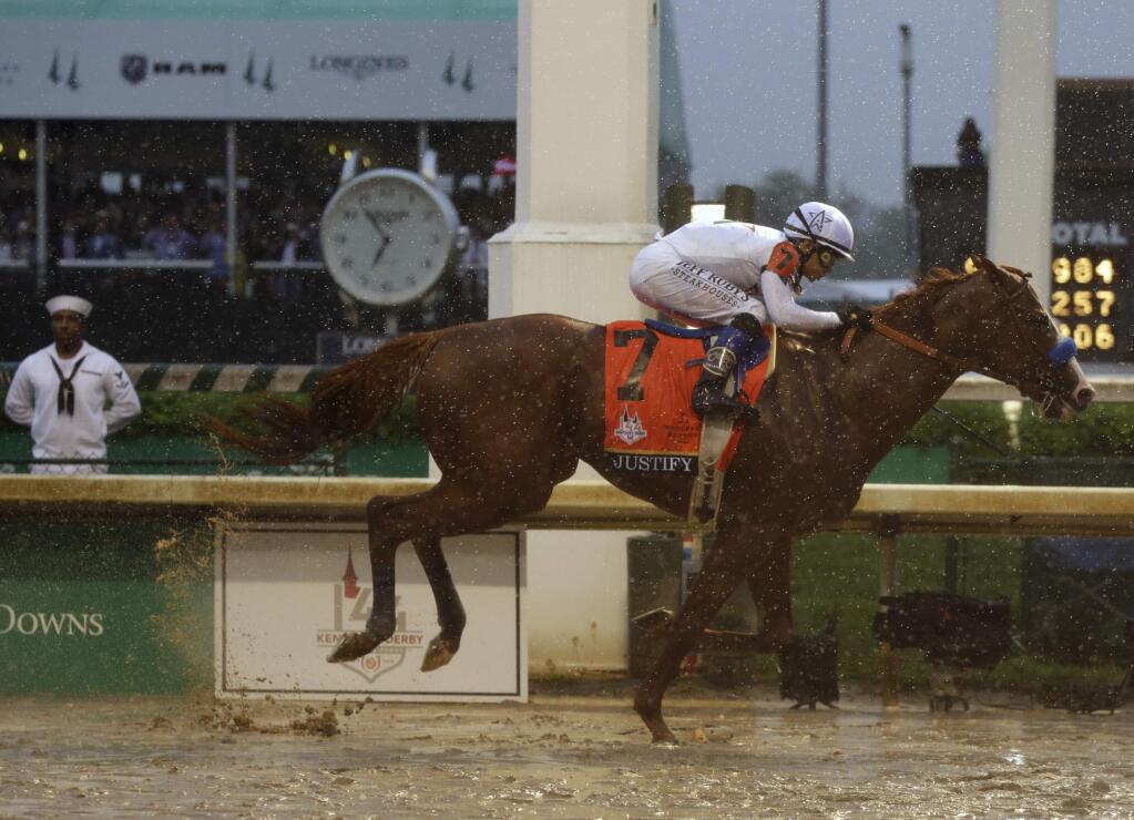 Mike Smith rides Justify to victory during the 144th running of the Kentucky Derby horse race at Churchill Downs Saturday, May 5, 2018, in Louisville, Ky. (AP Photo/Kiichiro Sato)